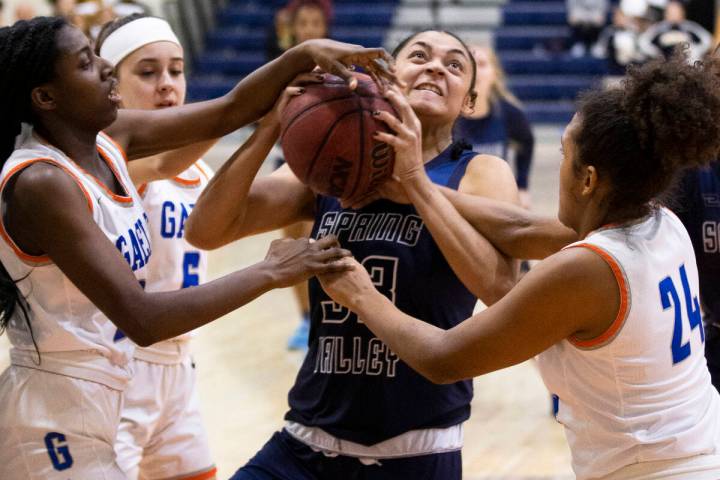 Spring Valley forward Briana Green (33) is fouled by Bishop Gorman forward Shaolin Cooper (24) ...