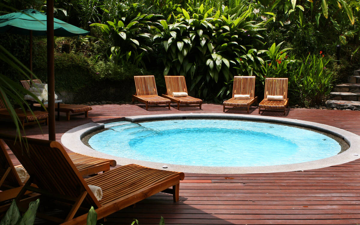 Lounge chairs surround a giant hot tub at this elegant five star resort