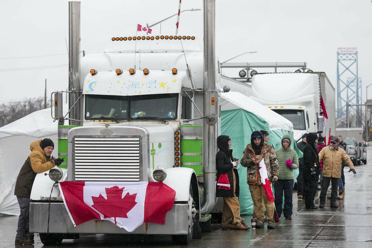 Truckers and supporters block the access leading from the Ambassador Bridge, linking Detroit an ...