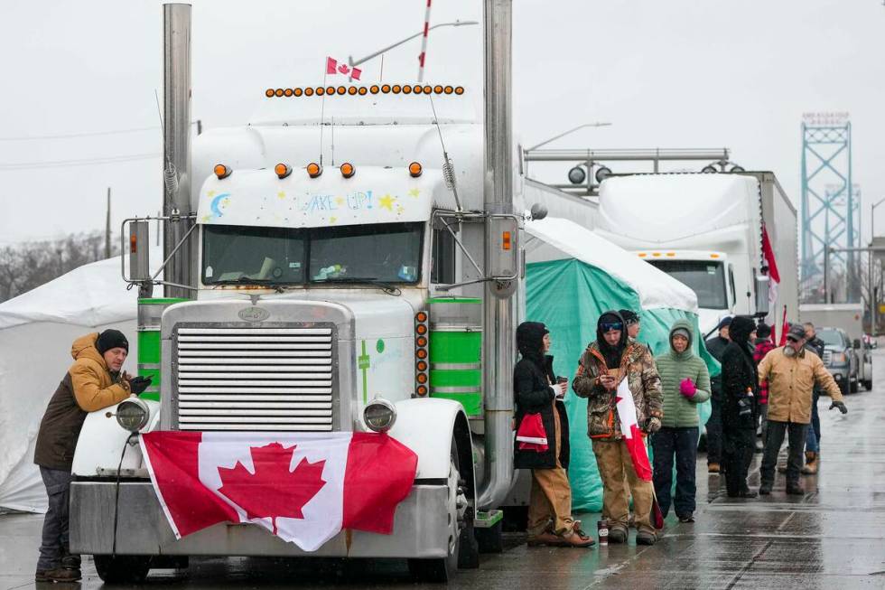 Truckers and supporters block the access leading from the Ambassador Bridge, linking Detroit an ...