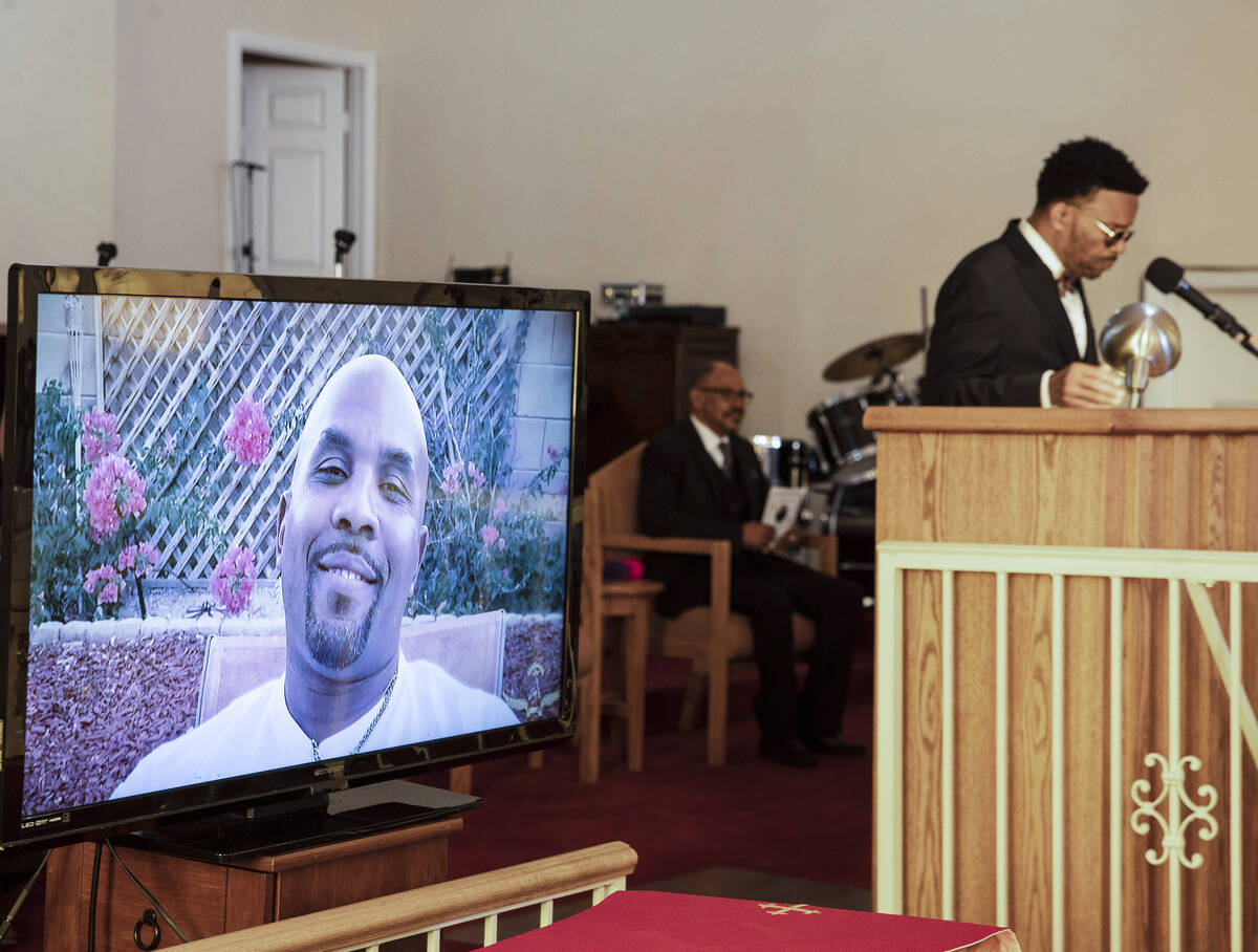 A photograph of Tanaga Miller, one of 9 people killed in the NLV crash, is displayed during his ...