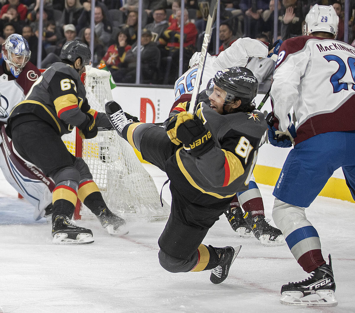 Golden Knights center Jonathan Marchessault (81) is hit by Colorado Avalanche center Nathan Mac ...