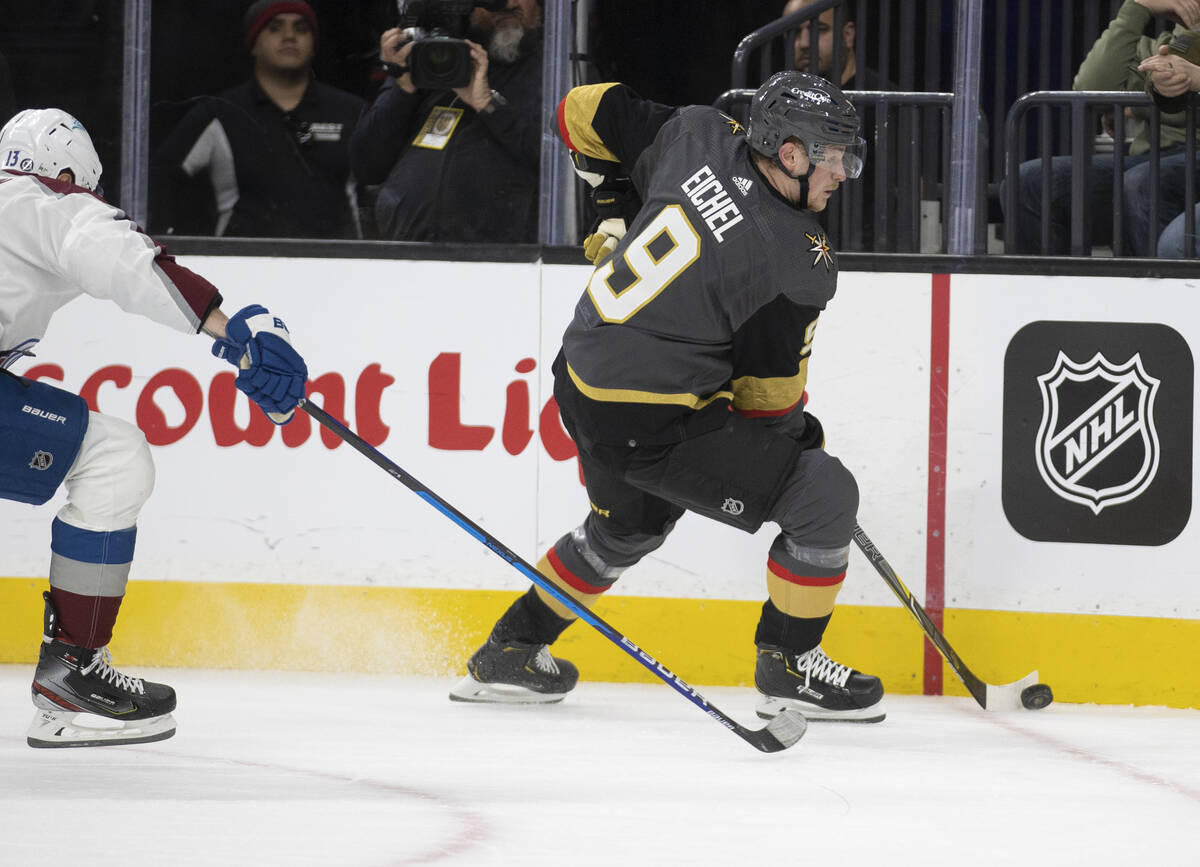 Golden Knights center Jack Eichel (9) pushes the puck up ice past Colorado Avalanche right wing ...