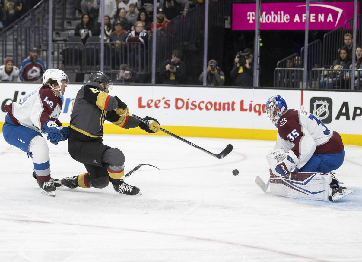 Golden Knights right wing Evgenii Dadonov (63) shoots on Colorado Avalanche goaltender Darcy Ku ...