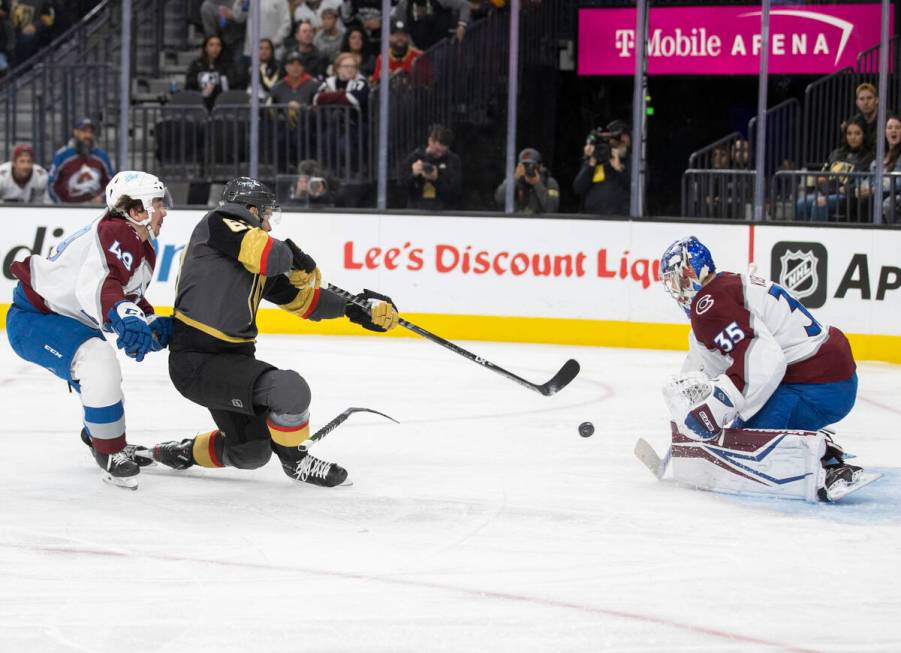 Golden Knights right wing Evgenii Dadonov (63) shoots on Colorado Avalanche goaltender Darcy Ku ...