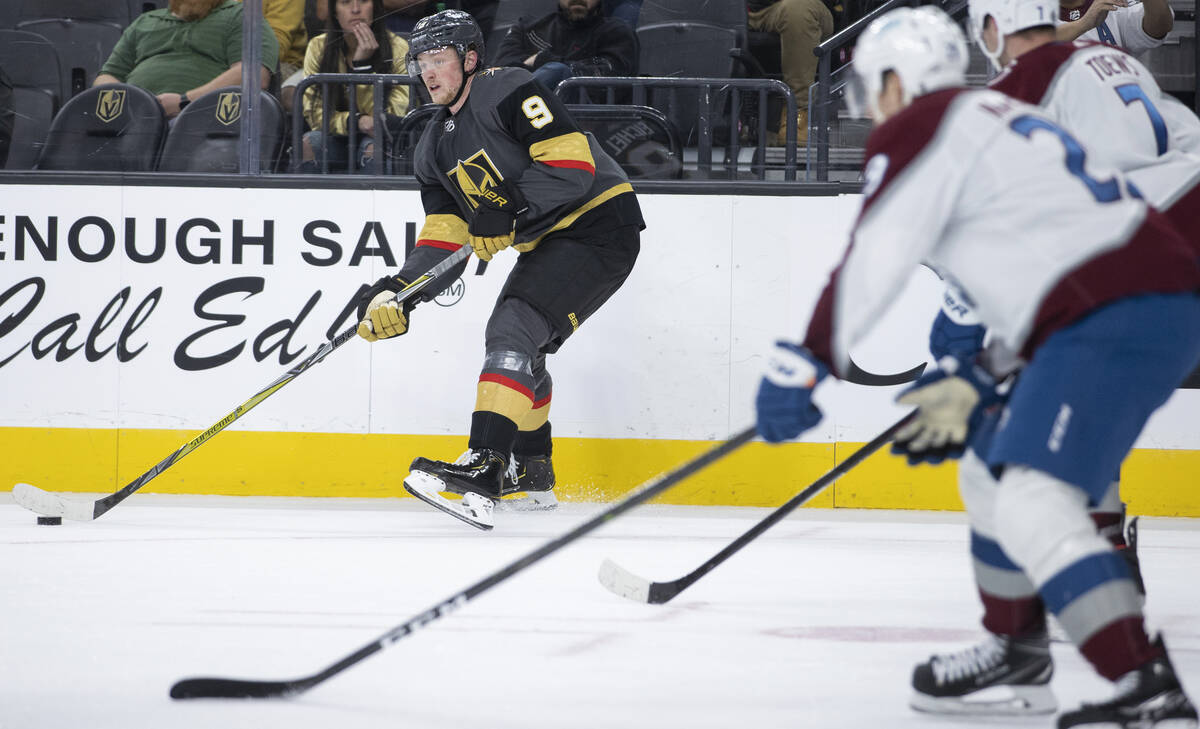 Golden Knights center Jack Eichel (9) makes a pass past Colorado Avalanche defenseman Devon Toe ...