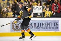 Fans of Golden Knights center Jack Eichel (9) watch him warm up before the start of an NHL hock ...