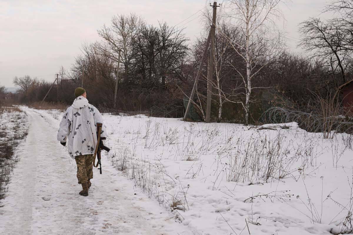 A Ukrainian serviceman walks to a frontline position outside Popasna, the Luhansk region, in ea ...