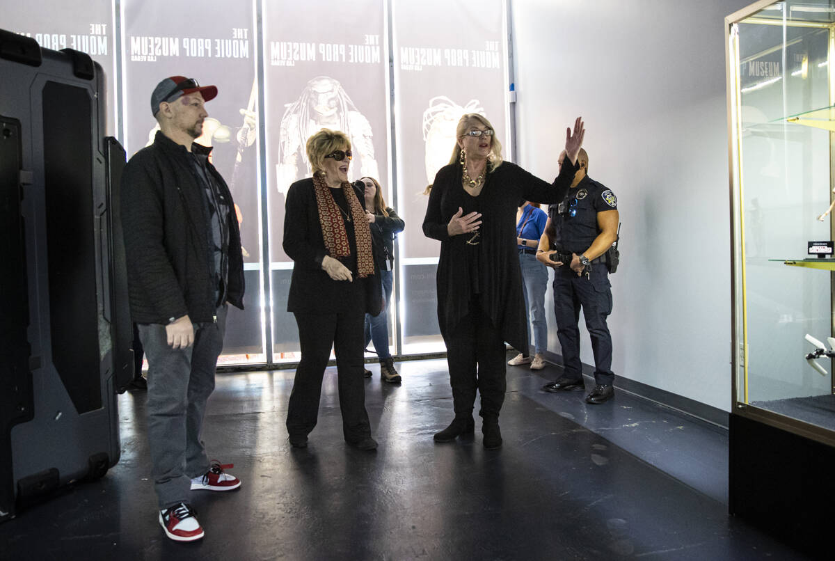 Tiana Armstrong, co-owner of The Movie Prop Experience, right, gives a tour of the museum to La ...