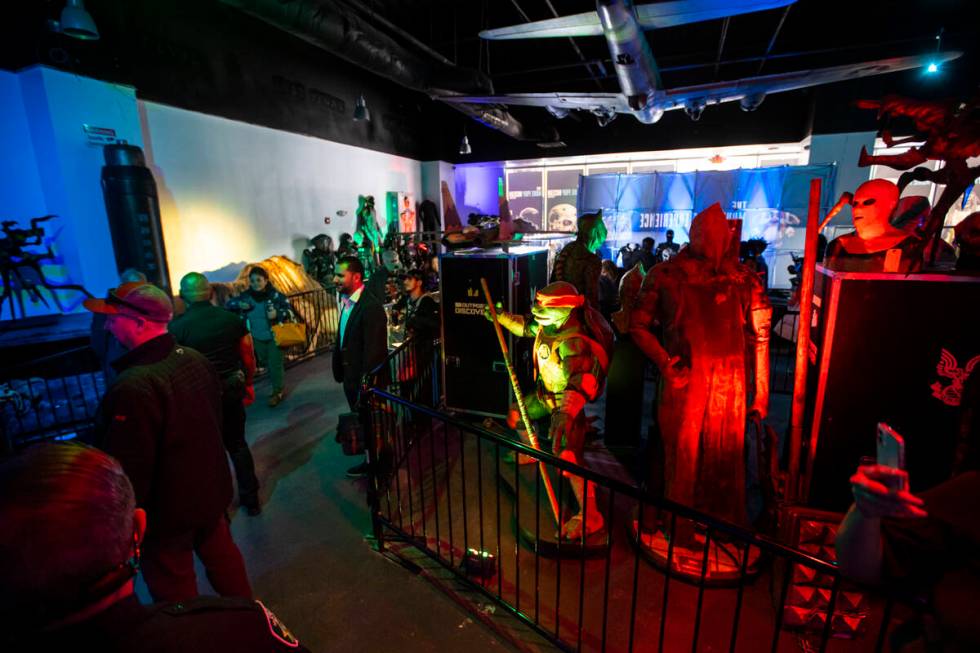 People explore The Movie Prop Experience during a preview at Neonopolis on Fremont Street Thurs ...