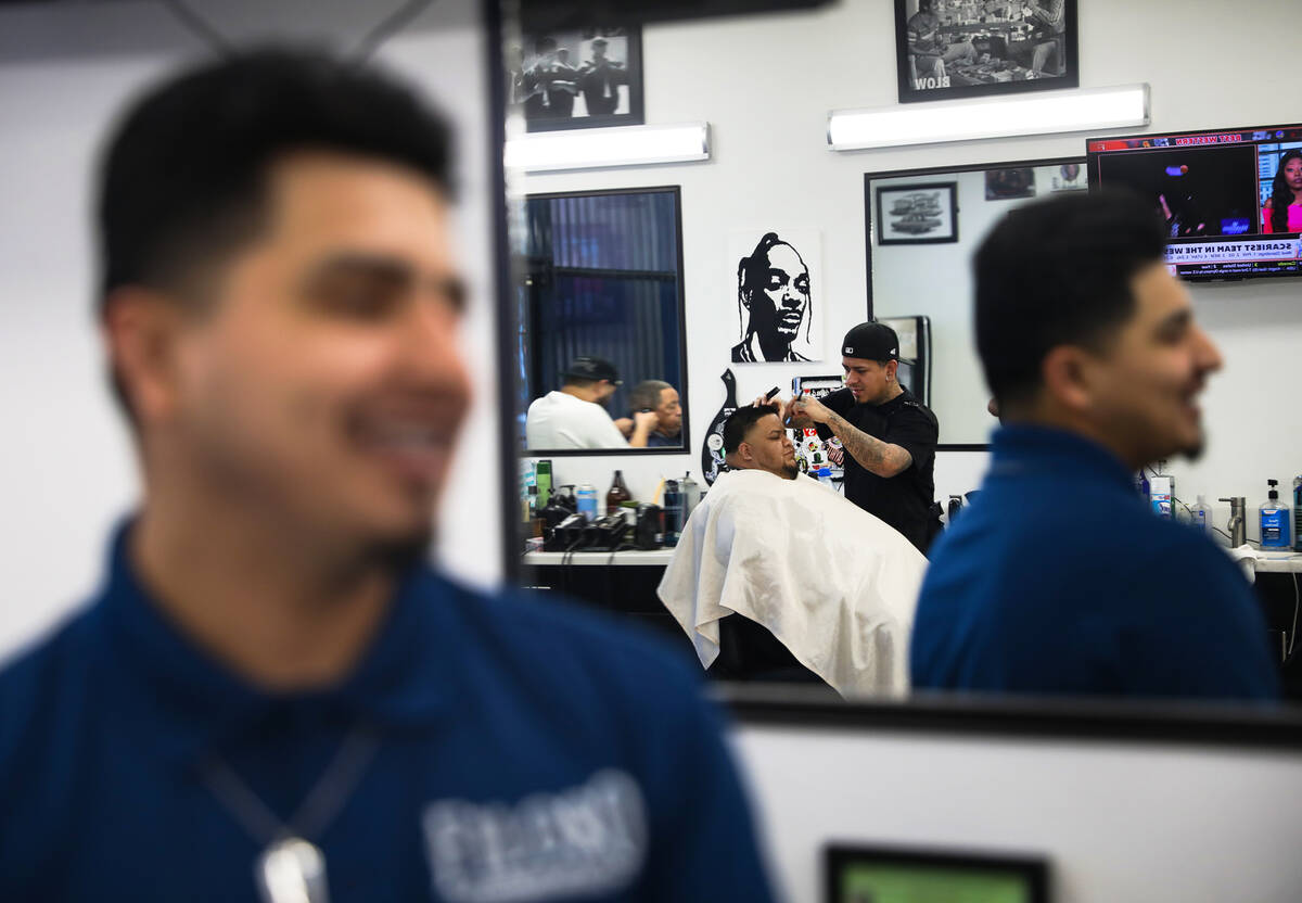 “Easy” Castro cuts the hair of Jesse Servin on Thursday, Feb. 17, 2022 at Icon Ba ...