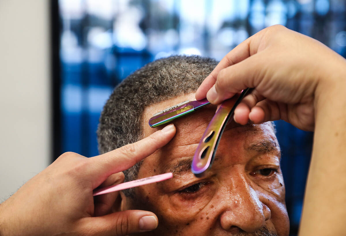 Geo Jimenez cuts the hair of Joseph Clark on Thursday, Feb. 17, 2022 at Icon Barbershop in Las ...