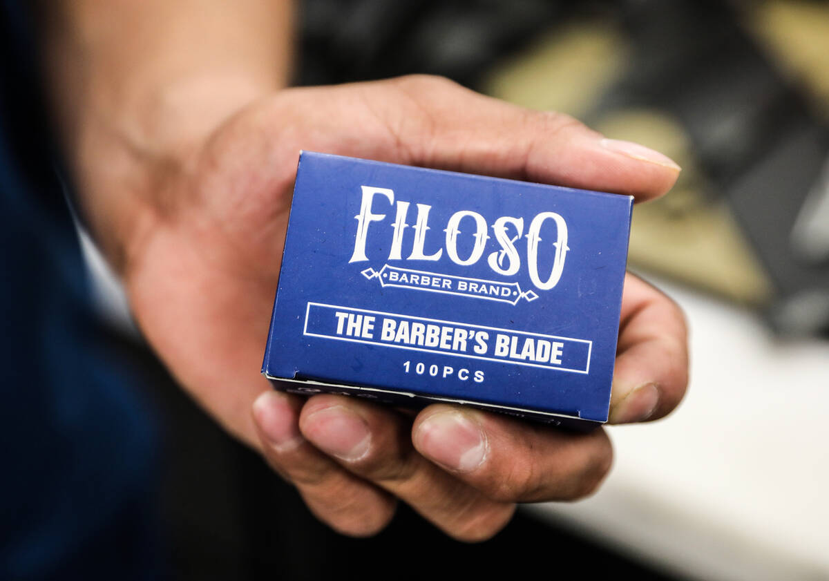 Francisco Carbajal shows a box of razors for his razor blade company, Filoso, at Icon Barbersho ...