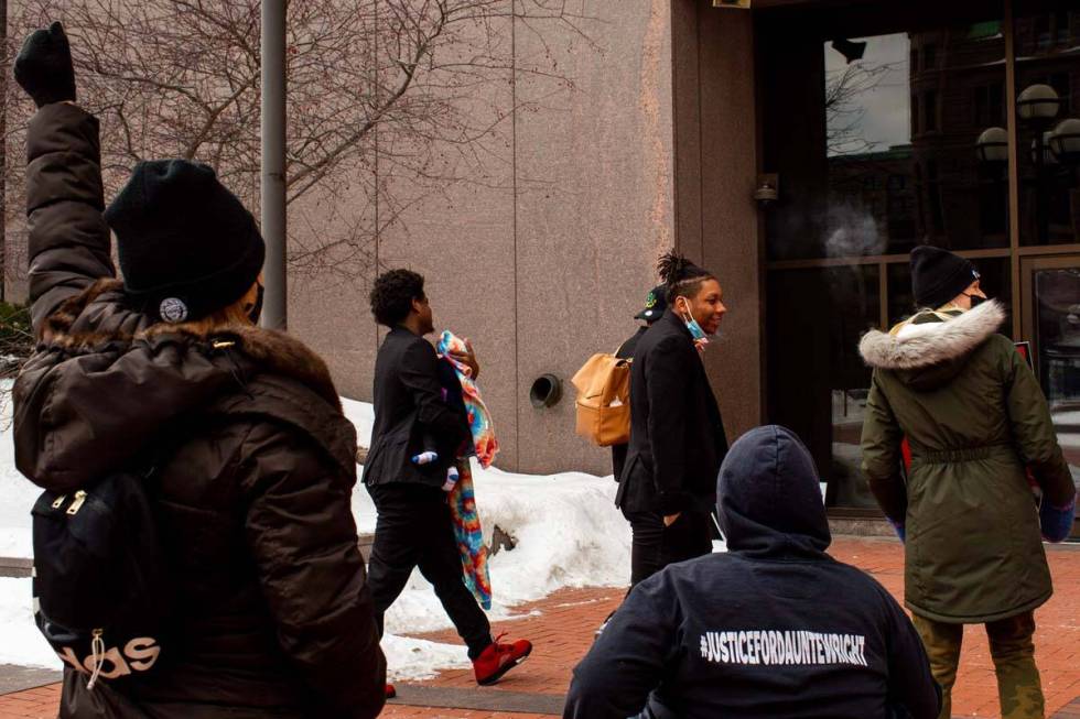 Friends of Daunte Wright walk into court in front of demonstrators calling for justice for Daun ...