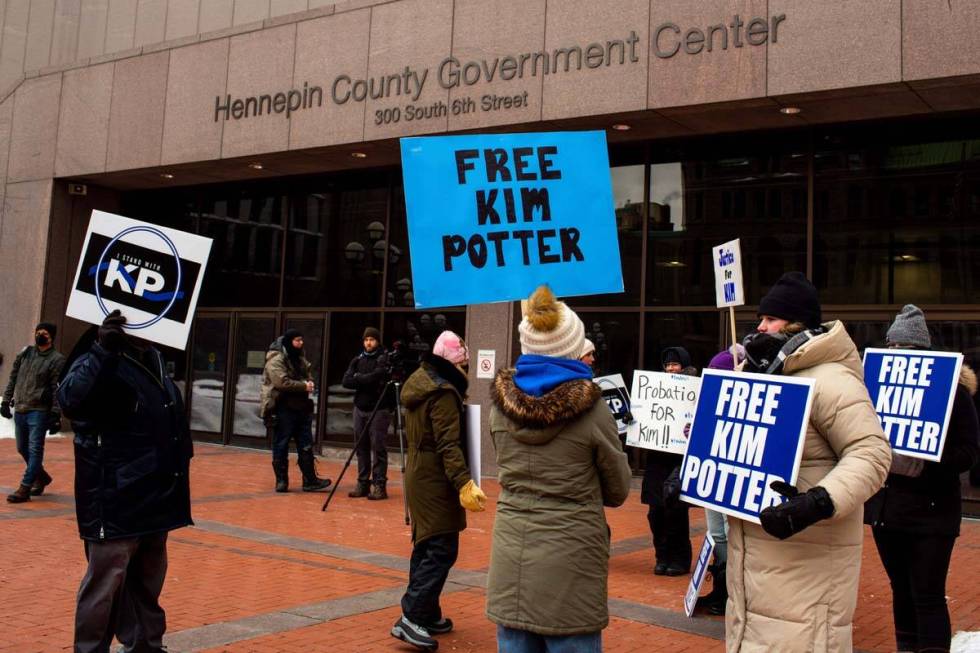 A group of demonstrators stand outside of Hennepin County Government Center calling for Kim Pot ...