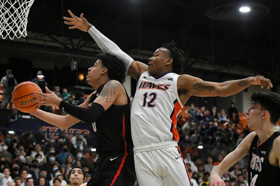 Gonzaga guard Julian Strawther (0) gets past Pepperdine forward Kendall Munson (12) for a shot ...