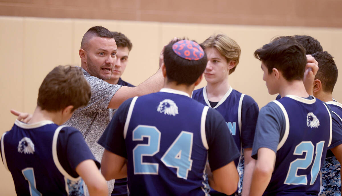 Adelson coach Kurt McGinnis instructs his players during a time out in the third quarter of the ...
