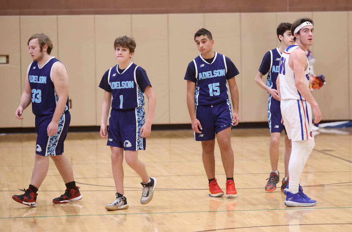 Adelson’s players Zachary Rosenfeld (33), Max Fine (1) and Michael Harouni (15) and Gree ...