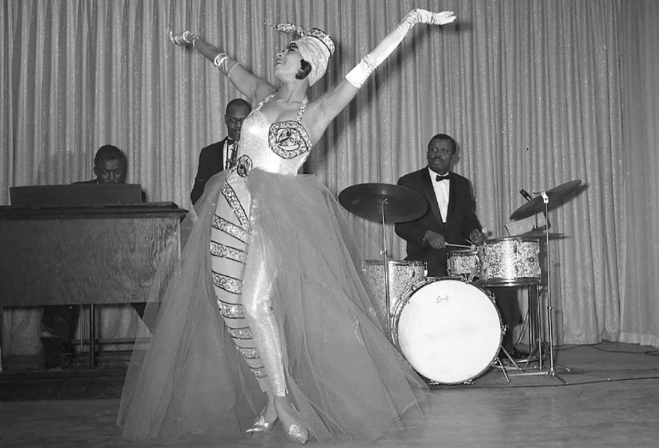 Diana Valdez, one of two dancers known as the ‘Exotic Twisters’, on stage in front of the b ...