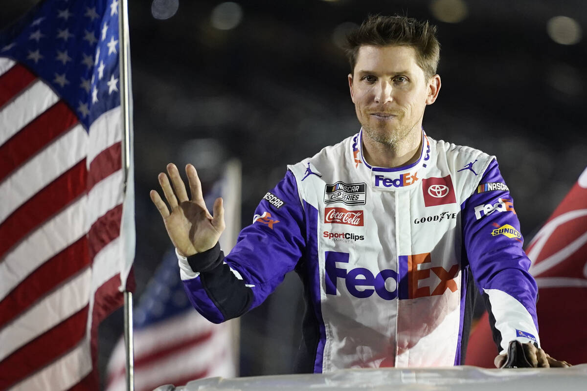 Denny Hamlin waves to fans during driver introductions before a NASCAR Daytona 500 qualifying a ...