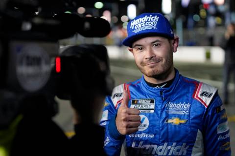 Kyle Larson gives a thumbs up after winning the pole position during qualifying for the NASCAR ...