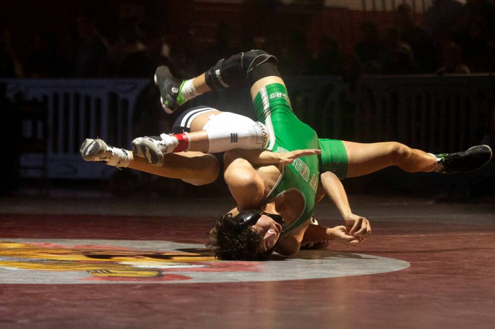 Kasius Graham from SLAM Nevada, left, takes Tyson Cuamba from Green Valley High School down dur ...