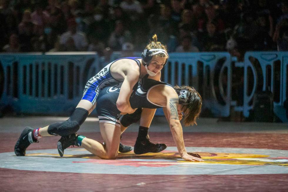 Jaxon Mackey from Basic High School, left, wrestles Saul Prado from SLAM Nevada in the 113-poun ...