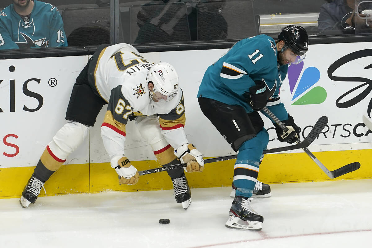 Vegas Golden Knights left wing Max Pacioretty (67) looks toward the puck next to San Jose Shark ...