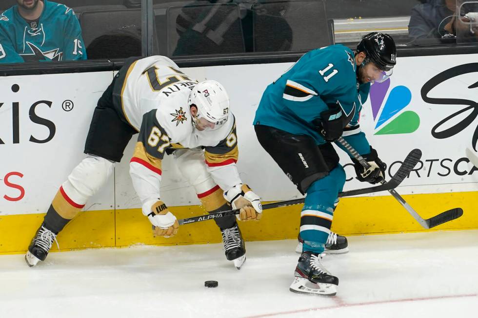 Vegas Golden Knights left wing Max Pacioretty (67) looks toward the puck next to San Jose Shark ...