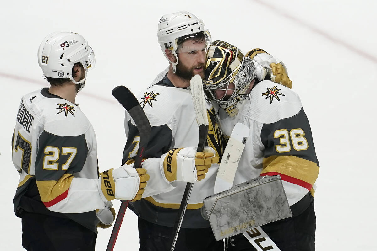 Vegas Golden Knights goaltender Logan Thompson (36) is congratulated by defenseman Alex Pietran ...