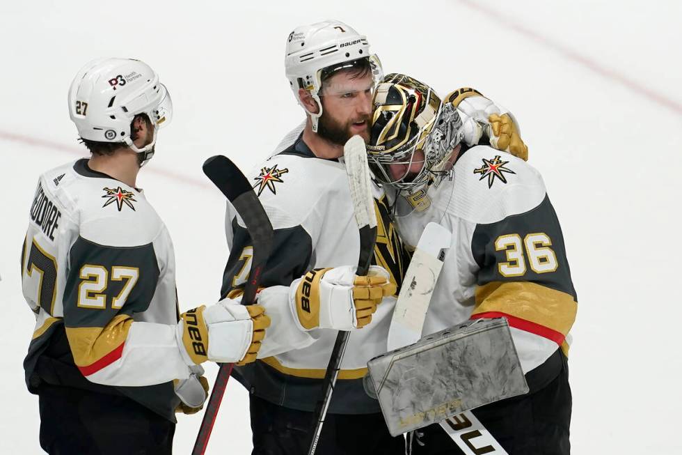 Vegas Golden Knights goaltender Logan Thompson (36) is congratulated by defenseman Alex Pietran ...