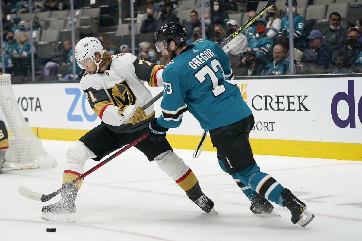 San Jose Sharks center Noah Gregor, right, reaches for the puck next to Vegas Golden Knights ce ...