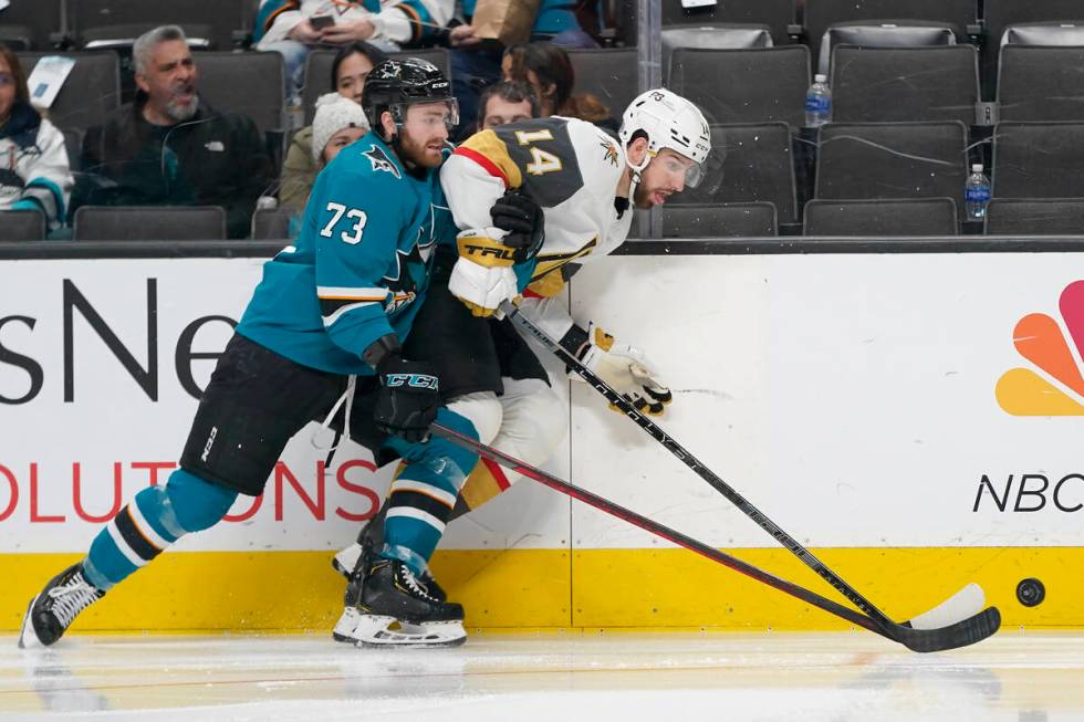 San Jose Sharks center Noah Gregor (73) reaches for the puck behind Vegas Golden Knights defens ...