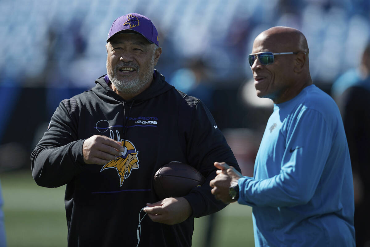 Minnesota Vikings running backs coach Kennedy Polamalu (left) chats with Carolina Panthers pass ...