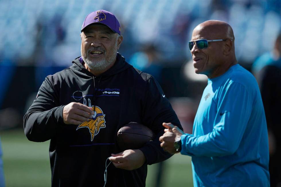 Minnesota Vikings running backs coach Kennedy Polamalu (left) chats with Carolina Panthers pass ...