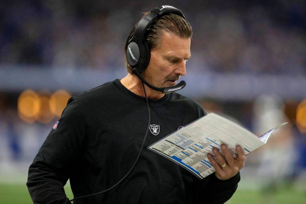 Raiders offensive coordinator Greg Olson looks at his plays during the second half of an NFL fo ...