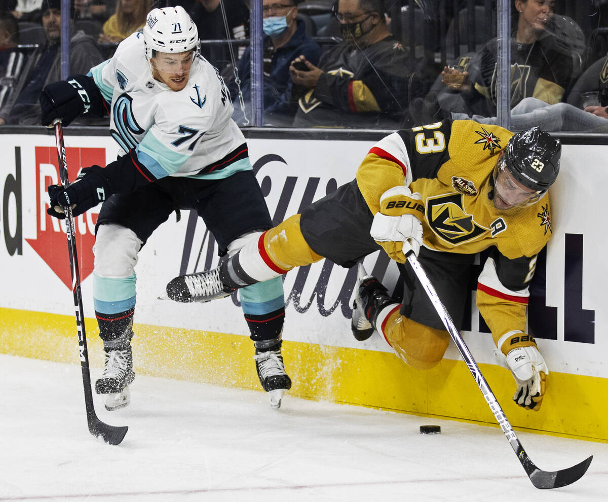 Vegas Golden Knights defenseman Alec Martinez (23) collides with Seattle Kraken left wing Max M ...