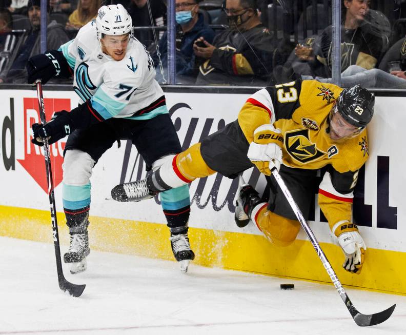 Vegas Golden Knights defenseman Alec Martinez (23) collides with Seattle Kraken left wing Max M ...