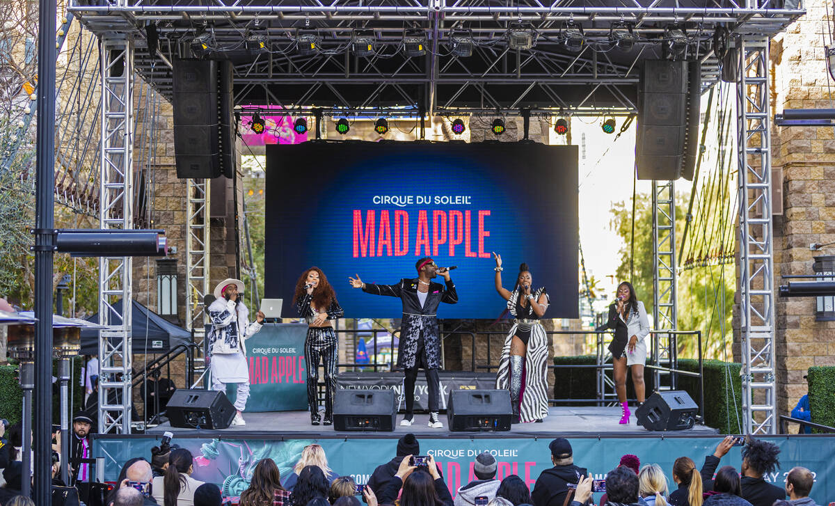 Singers in the new Cirque du Soleil show "Mad Apple" perform outside New York-New York during a ...