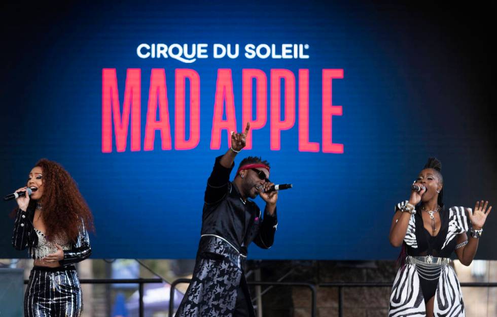 Singers in the new Cirque du Soleil show "Mad Apple" perform outside New York-New York during a ...