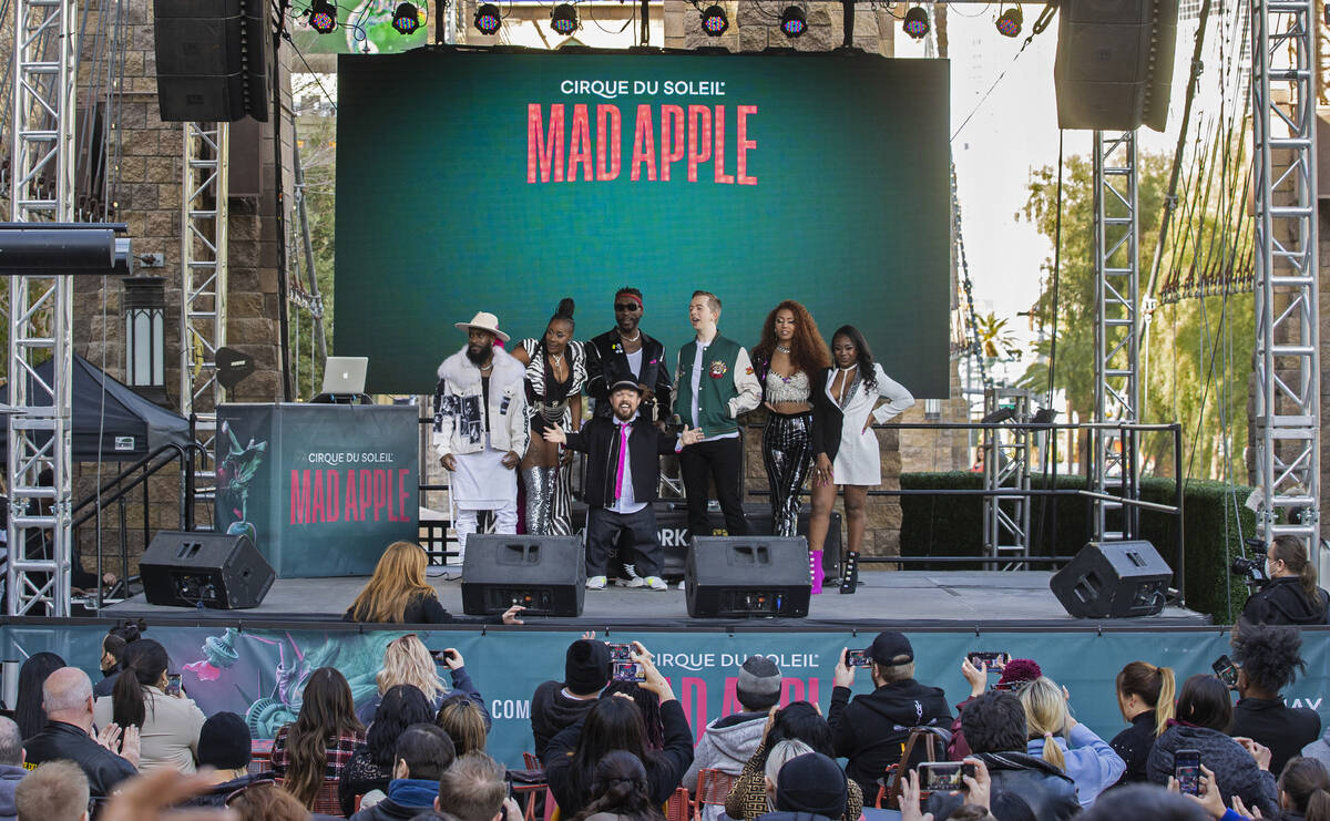 Members of the cast of the new Cirque du Soleil show "Mad Apple" pose for photos outside New Yo ...