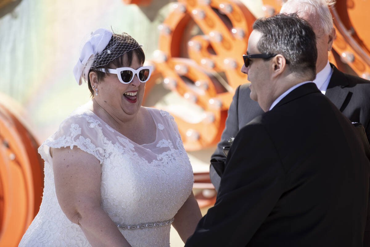 Stephanie Hippensteel, left, and Javier Ansoleaga, get married at the Neon Museum in Las Vegas, ...