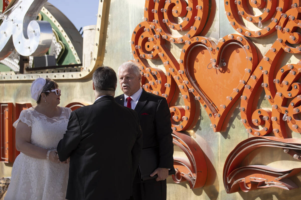 Pastor Peter Starzyk, far right, leads the wedding ceremony for Stephanie Hippensteel, left, an ...