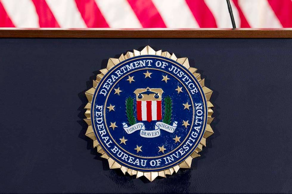 This June 14, 2018 file photo shows an FBI seal on a podium before a news conference at the age ...