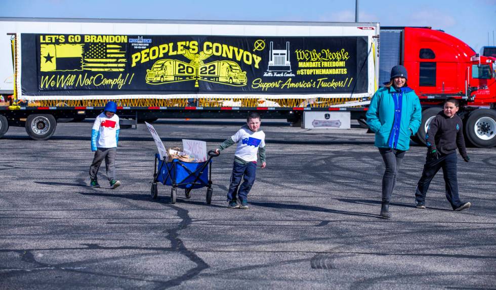 Attendees endure cold and high winds to pass out food donations to truck drivers for The People ...