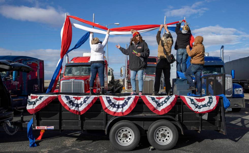 Organizers set up a stage for speakers for The People’s Convoy send off event at Adelant ...