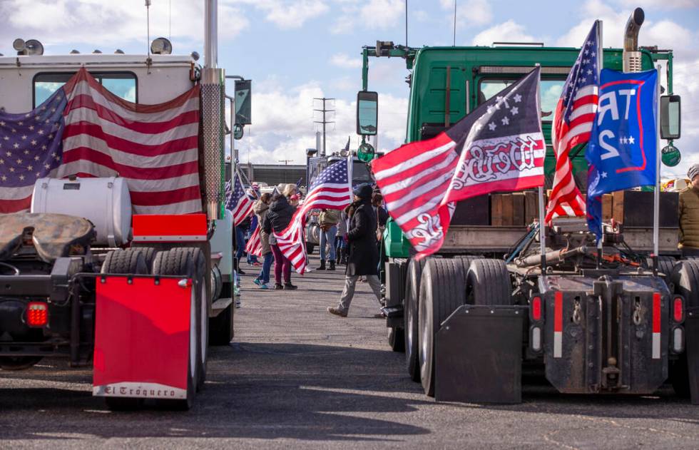 Flags and signs are plentiful during a departure event for The People’s Convoy at Adelan ...