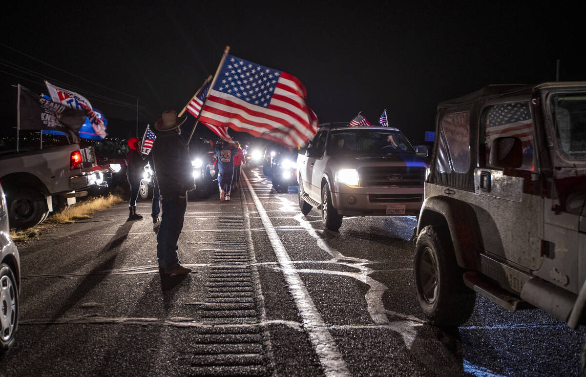 Supporter Greg Shelton of Kingman, Arizona, waves his flag as The People’s Convoy arrive ...