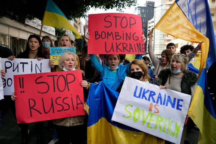 Ukrainians who live in Lebanon holds placards and chant slogans during a protest against Moscow ...
