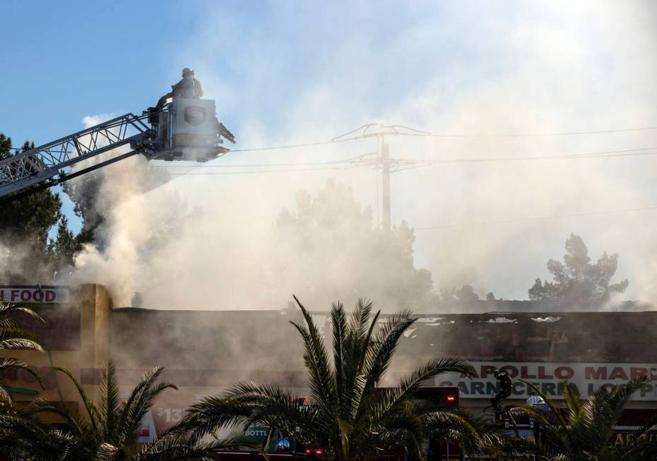 Las Vegas firefighters battle a two-alarm blaze at the Apollo Market on North Jones Boulevard o ...